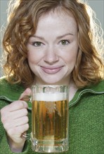Redheaded woman with mug of beer.