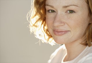 Portrait of smiling redheaded woman.