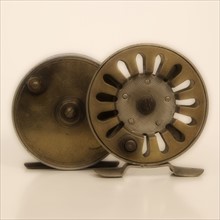 Two antique fishing reels.