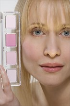 Woman's face with pink cosmetics.