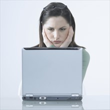 Frustrated woman with laptop.