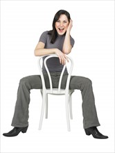Portrait of a woman sitting on a chair.