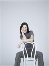 Smiling woman sitting on a chair.