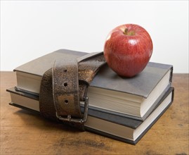 Schoolbooks with red apple.