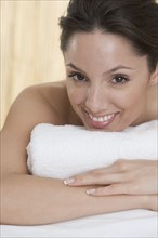 Headshot of smiling woman with towel.