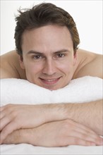 Headshot of smiling man with towel.