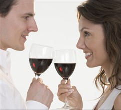 Profile of couple with red wine.