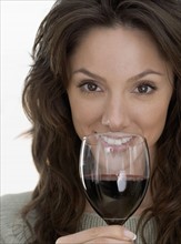Smiling woman with red wine.