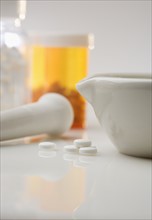 Pill bottles with mortar and pestle.