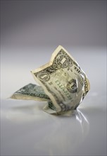 One crumpled dollar bill.
