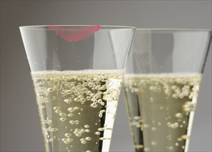 Closeup of champagne with lipstick print.