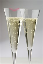 Champagne glasses with lipstick print.