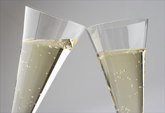 Closeup of toasting with champagne glasses.
