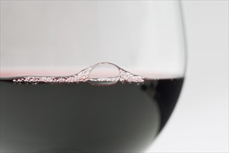 Closeup of bubbles in red wine.