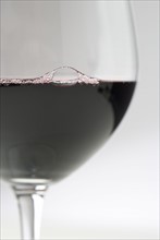 Closeup of red wine with bubbles.