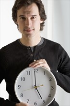 Closeup of man with clock.