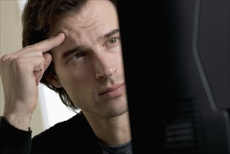 Closeup of man concentrating at computer.