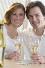 Smiling couple with white wine.