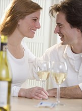Smiling couple with glasses of wine.