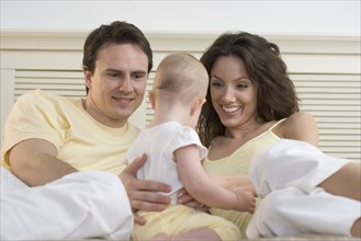 Couple relaxing with infant.
