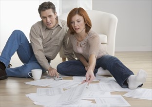 Couple with paperwork on floor.