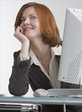 Smiling business woman with computer.