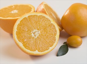 Several halved oranges with kumquat.