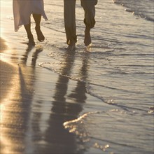 Couple strolling on a beach.