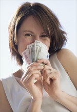 Woman holding Euro bills.