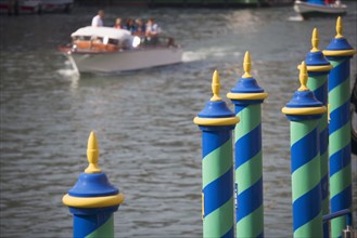 Mooring poles along the Grand Canal Venice Italy.