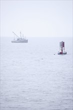 Lobster boat in fog off the Maine coast.