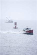 Lobster boat in fog off the Maine coast.