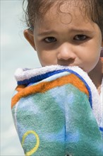 Closeup of child holding towel.