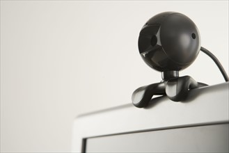 Closeup of webcam attachment on computer.