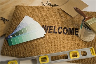 Welcome mat with paint and tools.