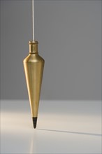 Plumb bob suspended from plumb line.