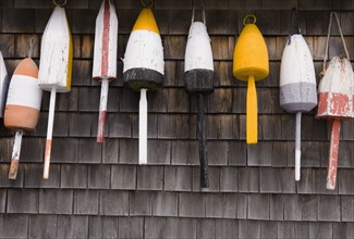 Buoys on the side of a wall in Maine.
