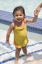 Girl standing in swimming pool.