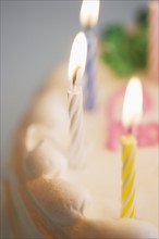 Lit candles on a birthday cake.
