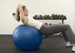 Woman using exercise ball.
