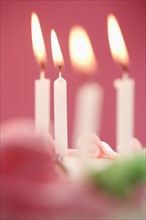 Closeup of candles on a cake.
