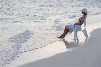 Woman sitting at the beach.