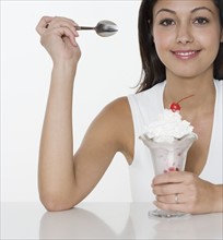 Smiling woman with ice cream sundae.