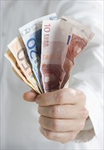 Closeup of fistful of European money.