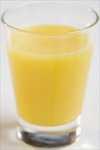 Closeup of glass of orange juice.