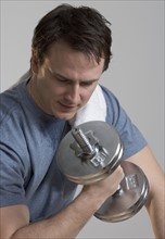 Sweating man lifting weights.