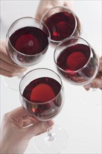 Closeup of hands toasting with wine.