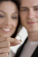 Closeup of blurred couple with ring.
