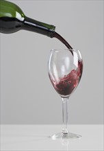 Wine pouring from bottle to glass.