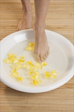 Stepping into footbath with flowers.